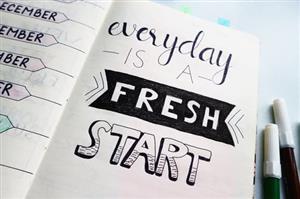 Open Planner with words that say "every day is a fresh start"